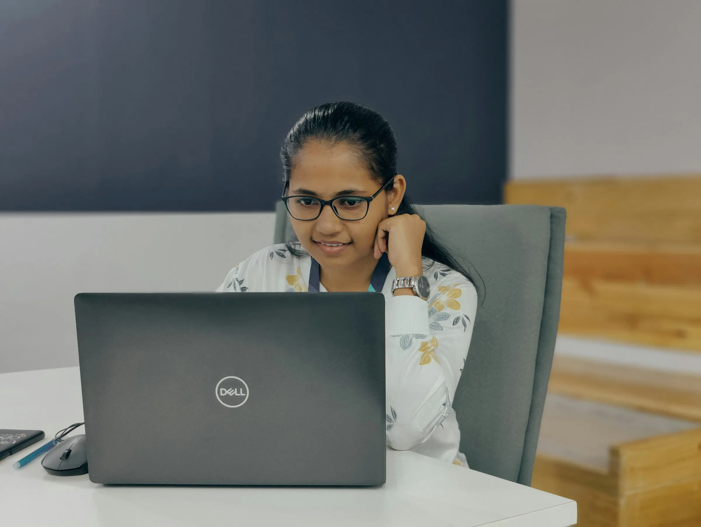 A woman at a laptop in an office, on a call