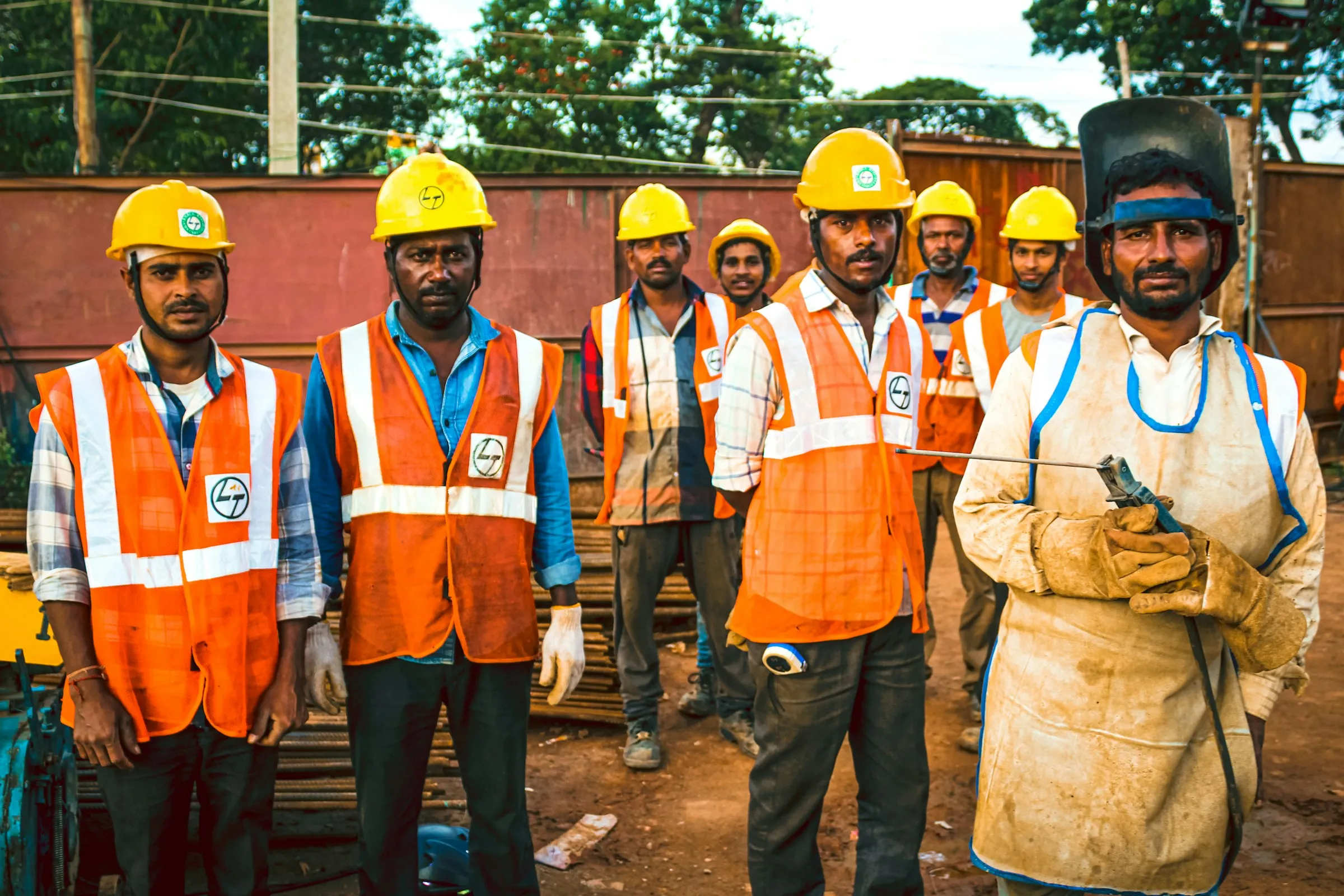 Site workers in reflective vests and hard hats